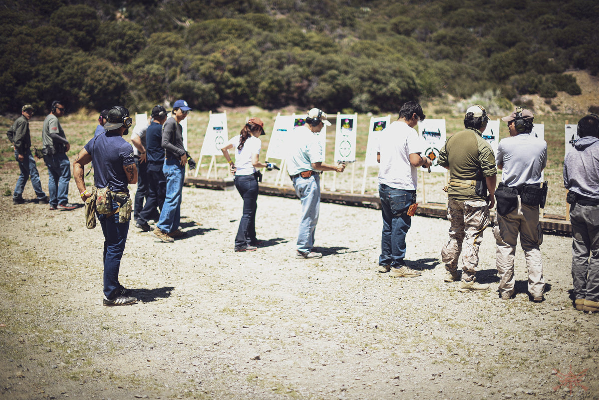 A 2 Alpha Training Group class working a pistol line on an outdoor range.