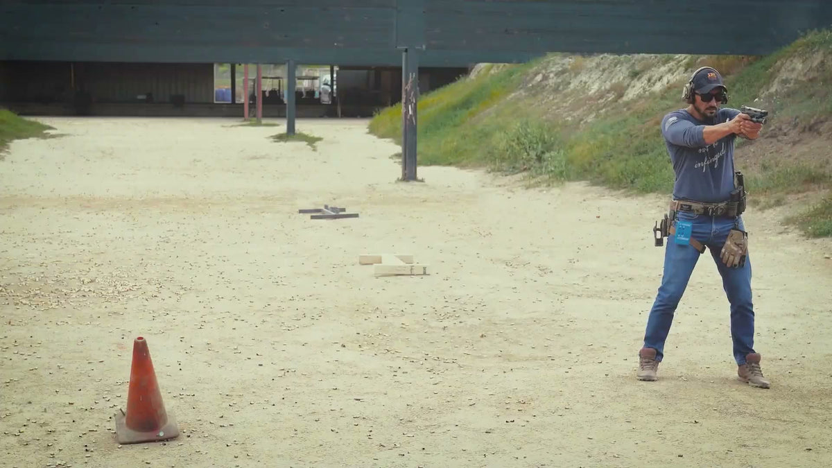 Kawa firing a pistol at the range